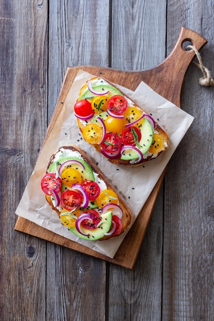 Bruschetta with avocado tomatoes onions and white cheese Vegetarian food Sandwich Italian food