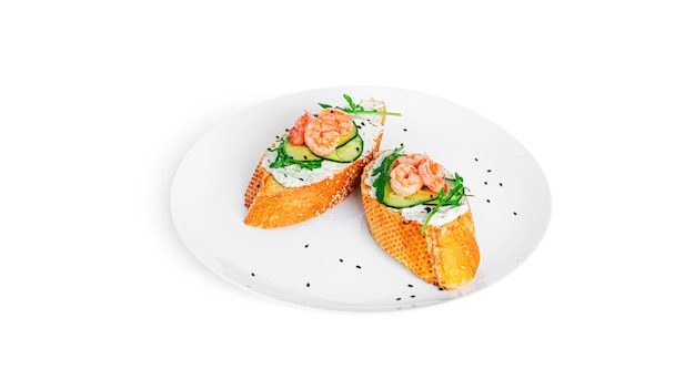 Bruschetta with cream cheese, shrimps, cucumber and arugula leaves isolated. Toast isolated. Sandwich isolated. Sandwich with shrimps, salmon and cheese