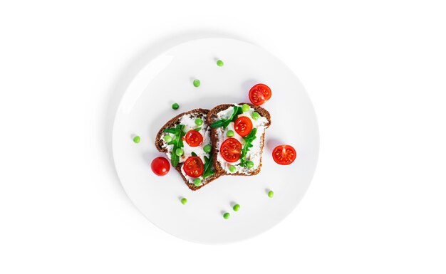 Bruschetta with cream cheese and vegetables isolated on a white background. Toasts isolated. Sandwich isolated. Sandwich with vegetables and cheese. High quality photo