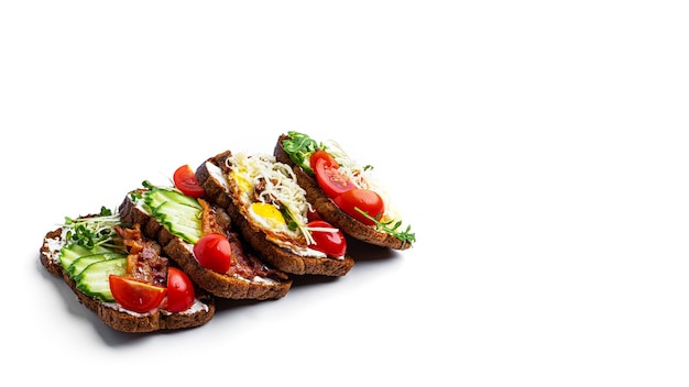 Bruschetta with different fillings on a white background. Vegetables, meat and cheese bruschetta. High quality photo