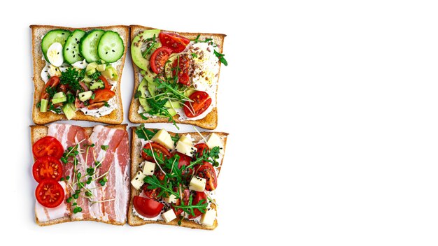 Bruschetta with different fillings on a white background. Vegetables, meat and cheese bruschetta. High quality photo