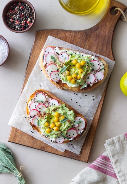 Bruschetta con guacamole ravanello formaggio bianco ceci e salvia cibo vegetariano panino cibo italiano