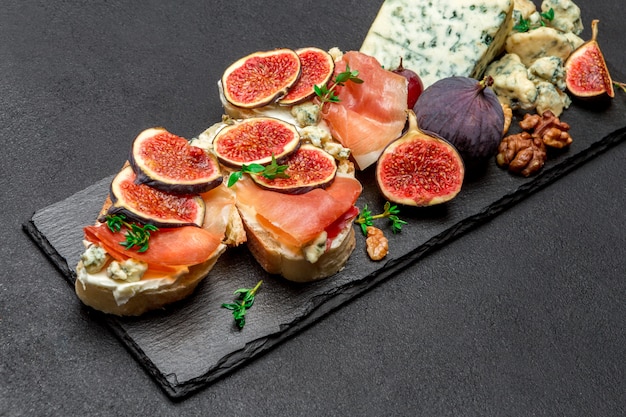 Foto bruschetta con prosciutto, ceese blu e fichi freschi