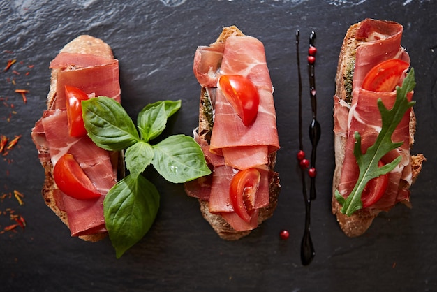 Bruschetta with hamon and sauce on black stone