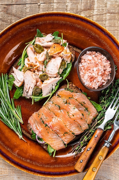 Bruschetta with hot and cold smoked salmon, arugula,