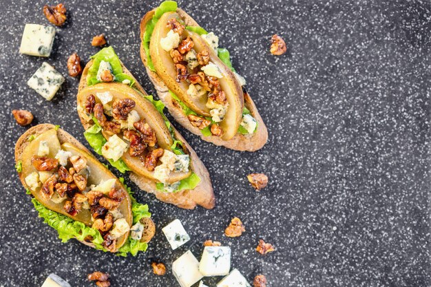 bruschetta with pear, honey, walnut, cheese, green salad and olive oil 