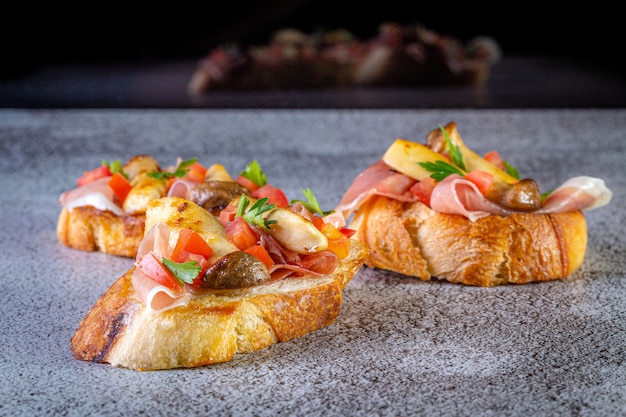 Bruschetta with prosciutto ham and tomatoes