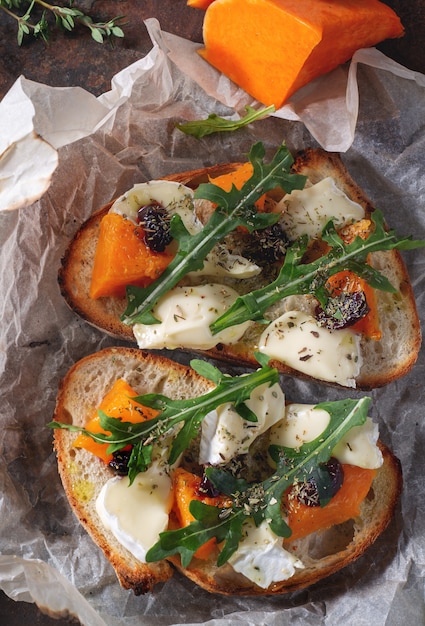 Bruschetta with pumpkin, cheese and arugula