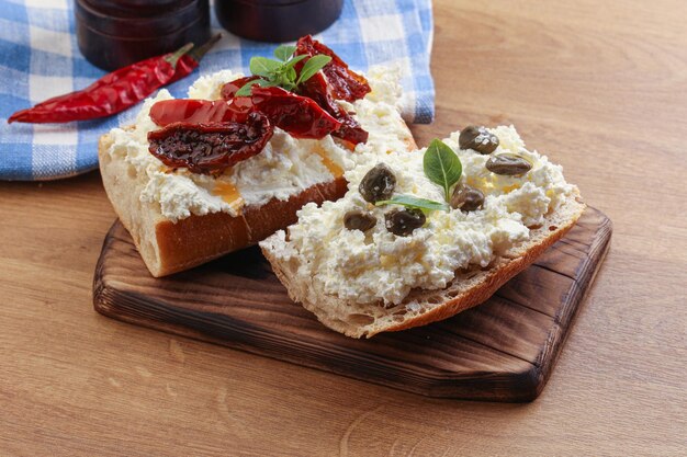 Bruschetta with soft cheese capers and dry tomato