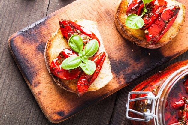 Bruschetta with sun dried tomatoes, basil leaves and garlic