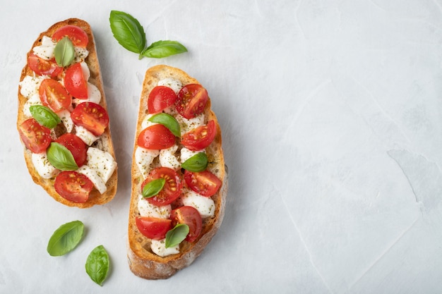 Bruschetta with tomatoes, mozzarella cheese and basil.