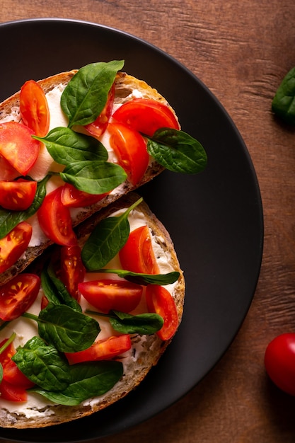 Bruschetta with tomatoes and spinach for breakfast