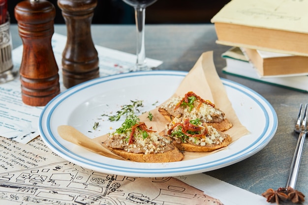 Bruschetta on a wooden table in a white plate