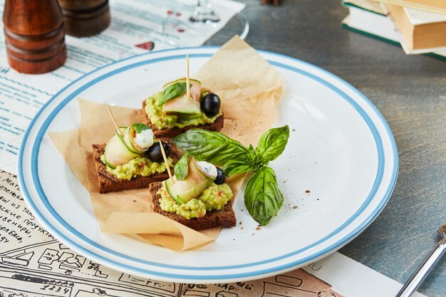 Bruschetta on a wooden table in a white plate