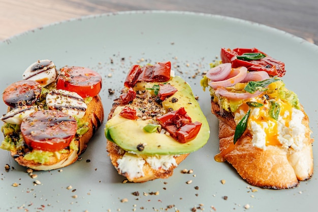 Bruschettas with avocado tomatoes mozzarella sundried tomatoes and spices