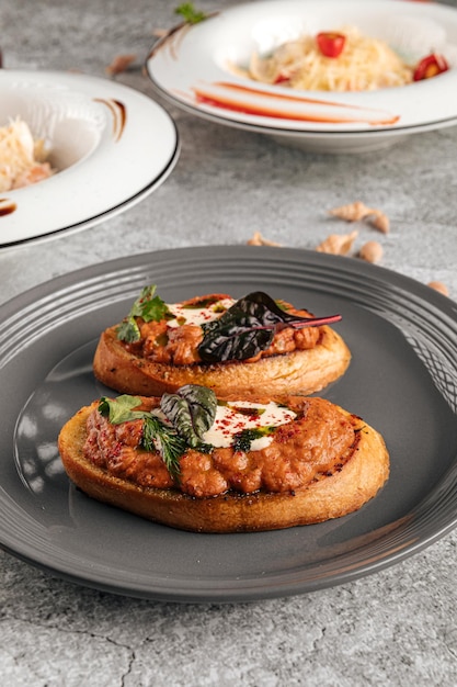 Bruschettas with eggplant aubergine spread on plate