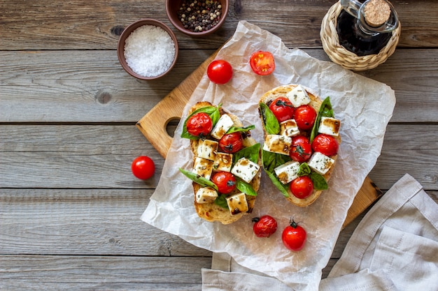 Bruschettas with tomatoes and cheese. 