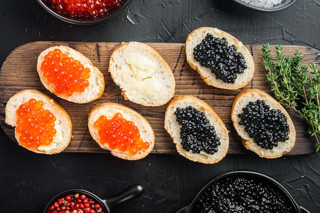 Bruschettes with butter red, and black caviar