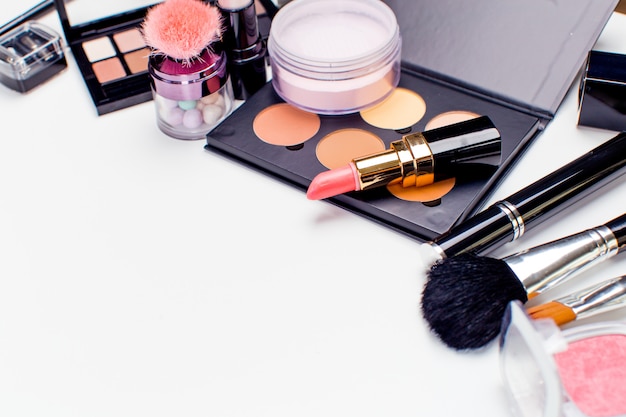 Brush and cosmetic isolated on a white surface. Top view.