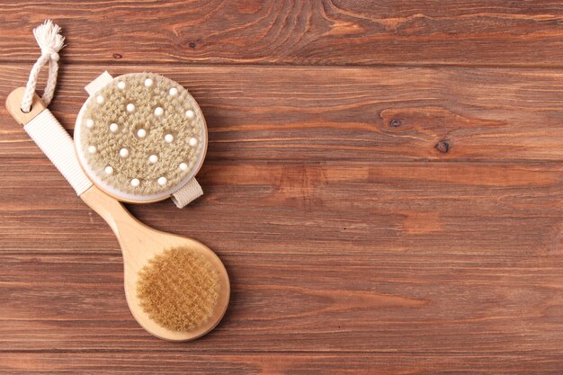 Brush for dry massage on a colored background top view