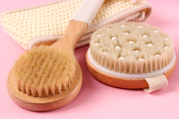 Brush for dry massage on a colored background top view