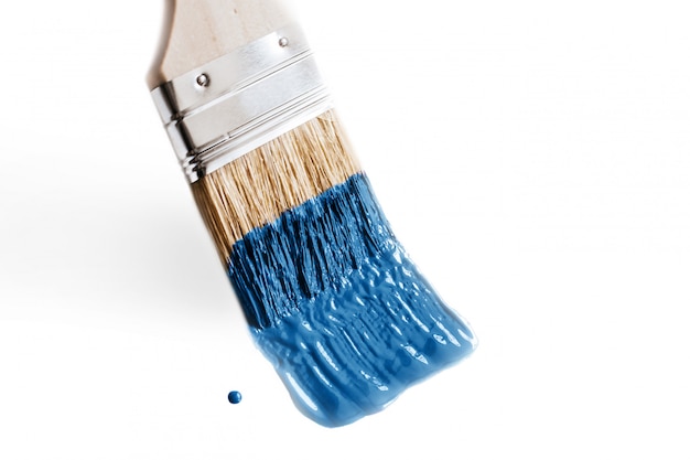 Brush in paint Classic blue color of the year 2020. Concept of change and renovation isolated