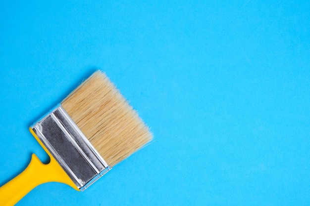 Brush for painting and repair on a blue background