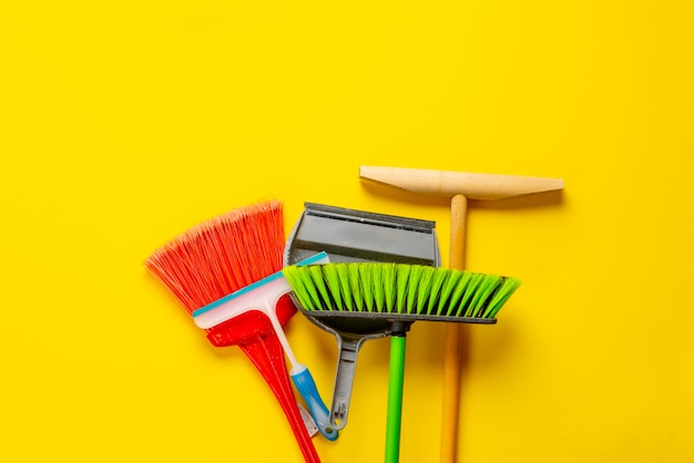 A brush scoop mop and other bunch of cleaning accessories set flat lay on the floor