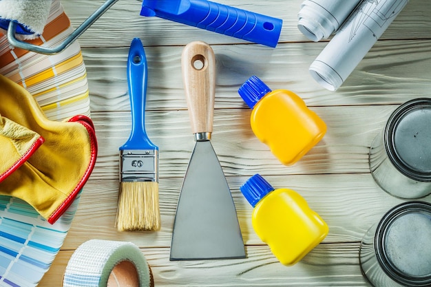 Photo brush and spatulla with many other construction tools on white wooden boards