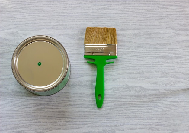 brush with green paint on a light background. renovation concept