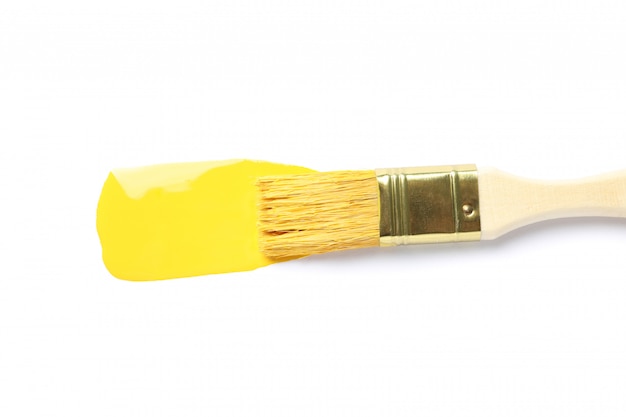 Brush and yellow paint stroke isolated on white isolated