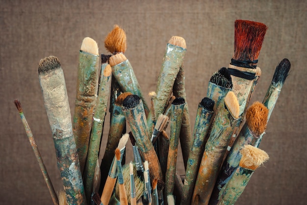 Artistic equipment: white artist canvas on easel, palette and paint brushes  in a artist studio. Retro toned. Stock Photo by ©ChamilleWhite 148244611