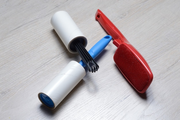 Brushes for cleaning clothes. sticky and a bristled brush, lie on a light-colored countertop.