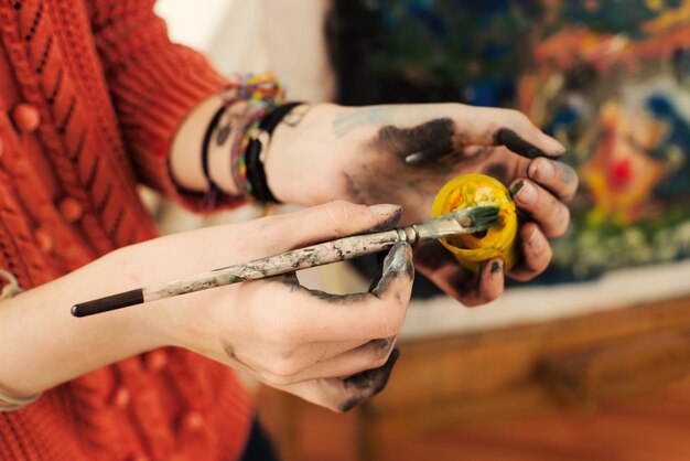 Photo brushes and oil paints in woman hands