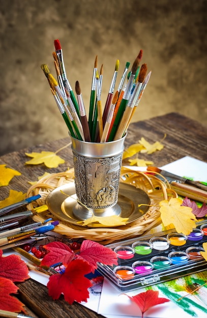 Brushes and paints for drawing in composition on the table