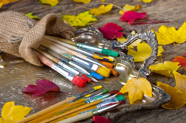 Brushes and paints for drawing in composition on the table