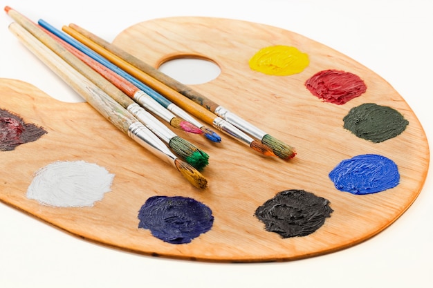 Brushes and paints for drawing in composition on the table