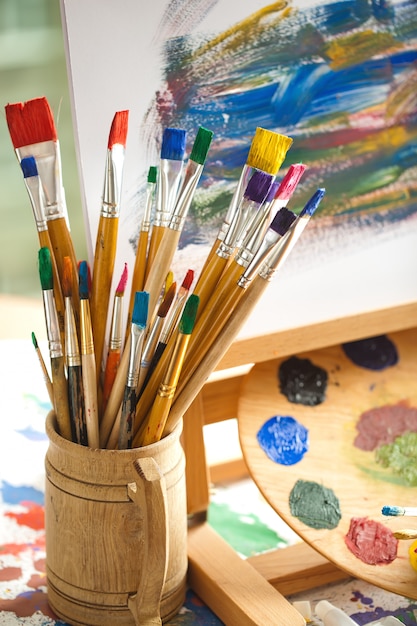 Brushes and paints for drawing in composition on the table