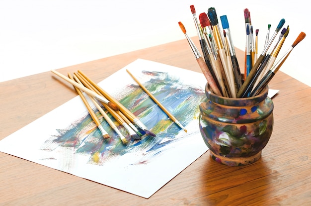 Brushes and paints for drawing in composition on the table