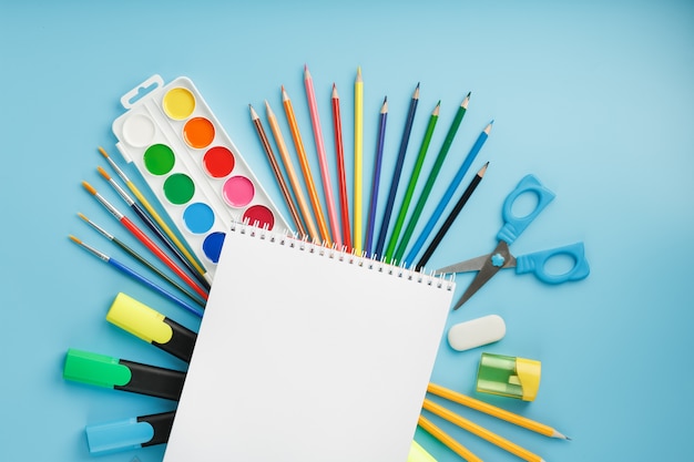 Brushes and paints with school supplies