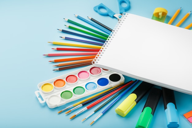 Brushes and paints with school supplies