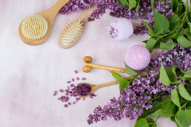 brushes, soap, bath salt and lilac branches 