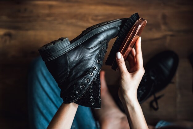 Brushing black leather shoes. Close-up.