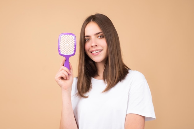 Brushing hair portrait young woman brushing straight natural hair with comb girl combing hair with h