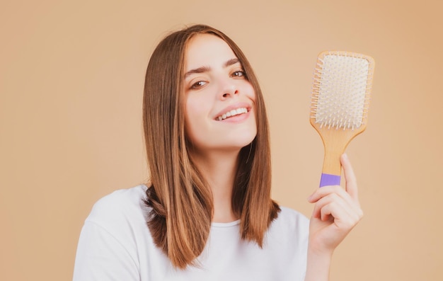 Brushing hair portrait young woman brushing straight natural hair with comb girl combing healthy hai