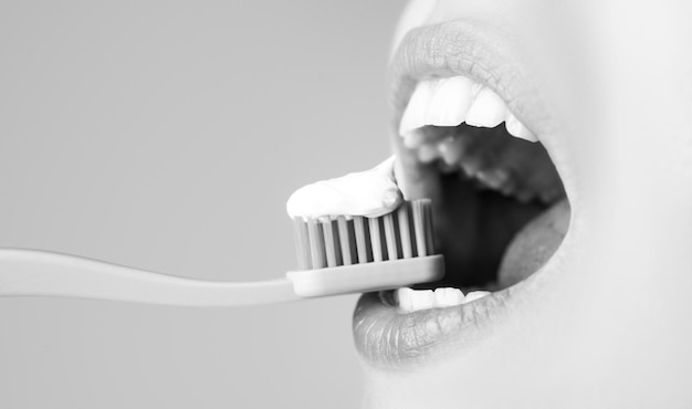 Brushing teeth close up woman with toothbrush closeup dental care