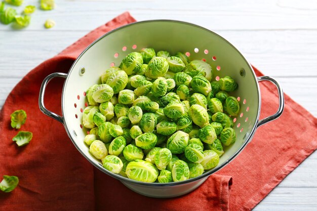 Brussels sprouts in colander on table