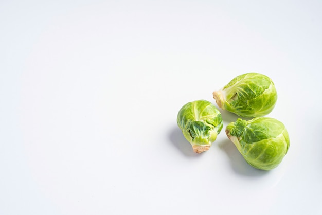 Brussels sprouts on green background, top view.