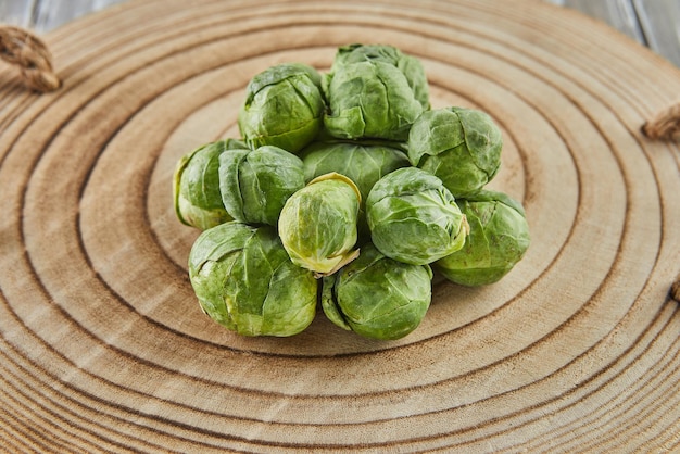 Brussels sprouts stacked in pile on wooden background