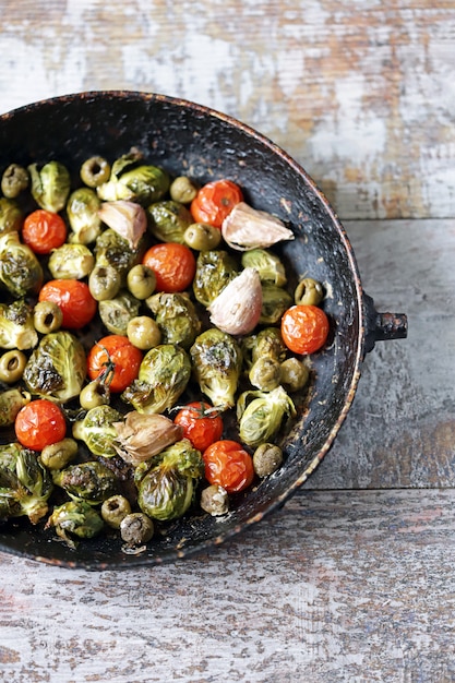 Brussels sprouts with vegetables and herbs in a pan